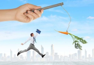 Funny image of businessman chased with carrot