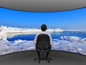 businessman sitting in movie house and looking at frozen sea
